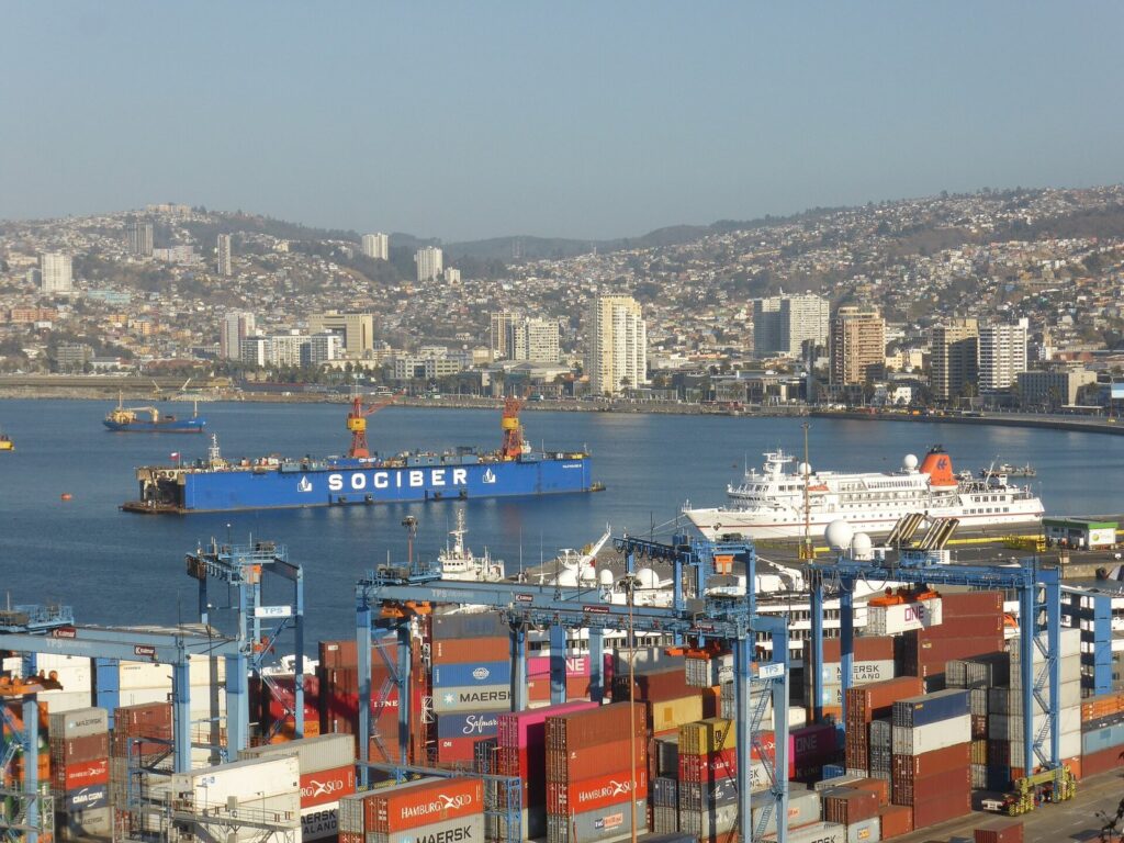 Valparaíso’s port, cranes and cruise ship in the bay with the city’s hills rising behind, seen from Cerro Artillería
