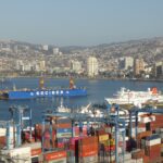 Valparaíso’s port, cranes and cruise ship in the bay with the city’s hills rising behind, seen from Cerro Artillería