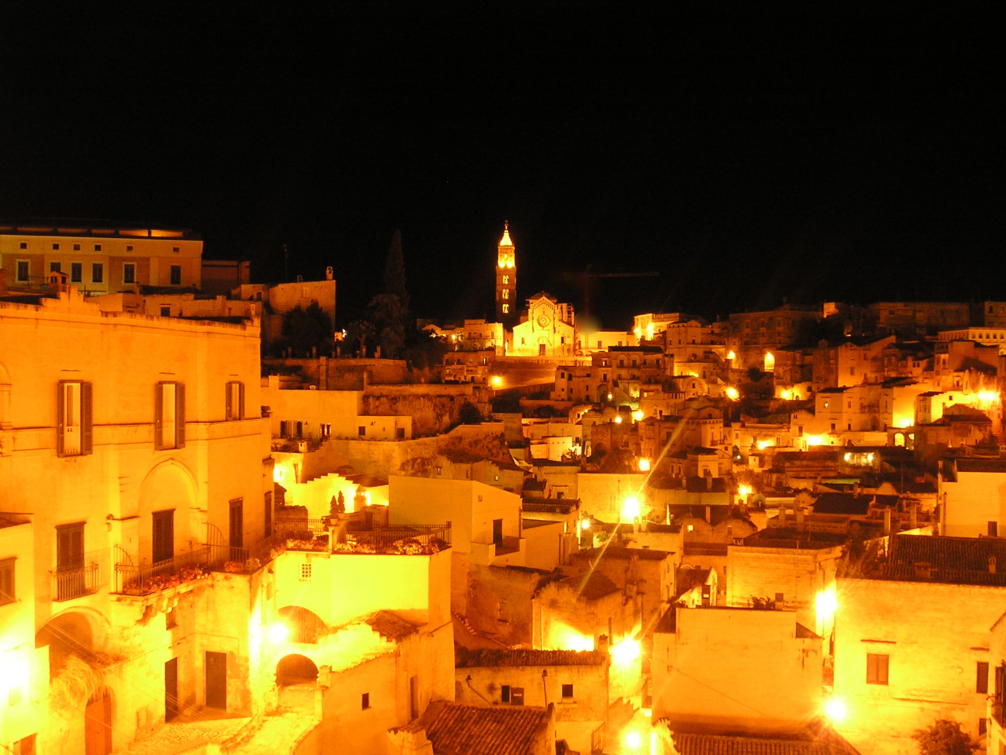 The Sassi after dark, when the inhabited rooms show as points of light in the cliff