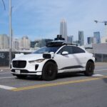 Waymo Jaguar I-PACE robotaxi driving in San Francisco with no one in the driver's seat